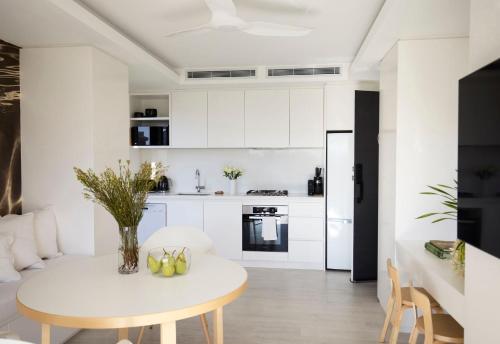 a kitchen and dining room with a table and chairs at Little Darling in Sydney