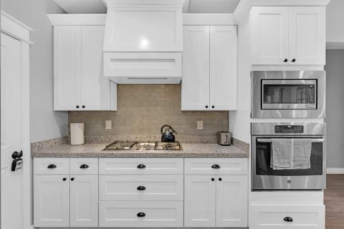 a white kitchen with white cabinets and a sink at Large Flagstaff Home Near Violas with Hot Tub in Flagstaff