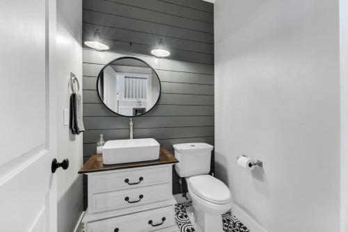 a bathroom with a white toilet and a mirror at Large Flagstaff Home Near Violas with Hot Tub in Flagstaff