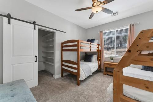 a bedroom with two bunk beds and a ceiling fan at Large Flagstaff Home Near Violas with Hot Tub in Flagstaff