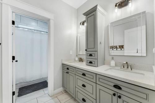 a white bathroom with a sink and a mirror at Large Flagstaff Home Near Violas with Hot Tub in Flagstaff
