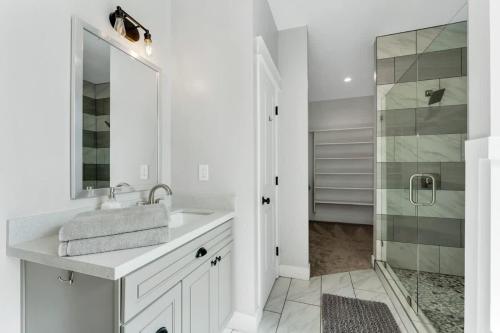 a white bathroom with a sink and a shower at Large Flagstaff Home Near Violas with Hot Tub in Flagstaff