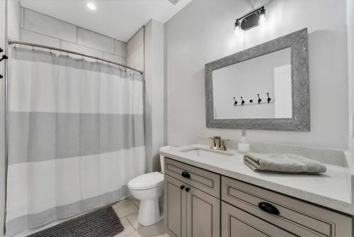 a bathroom with a sink and a toilet and a mirror at Large Flagstaff Home Near Violas with Hot Tub in Flagstaff