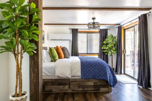 a bedroom with a bed with a blue and white comforter at The Pine Perch in Munds Park