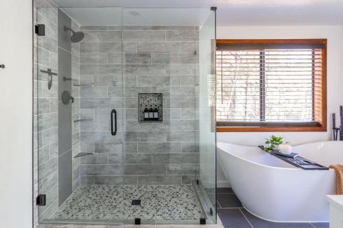 a bathroom with a tub and a shower stall at The Pine Perch in Munds Park