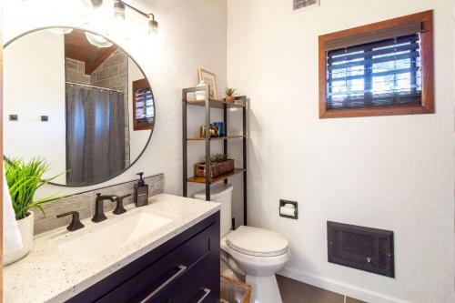 a bathroom with a sink and a toilet and a mirror at The Pine Perch in Munds Park