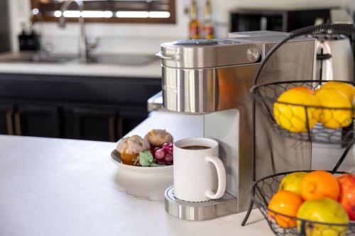 a coffee maker sitting on a counter with a bowl of fruit at The Pine Perch in Munds Park