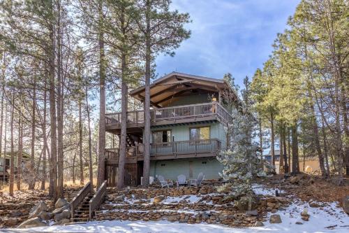 a house with a deck in the woods at The Pine Perch in Munds Park