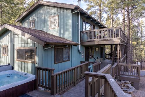 a house with a hot tub on a deck at The Pine Perch in Munds Park