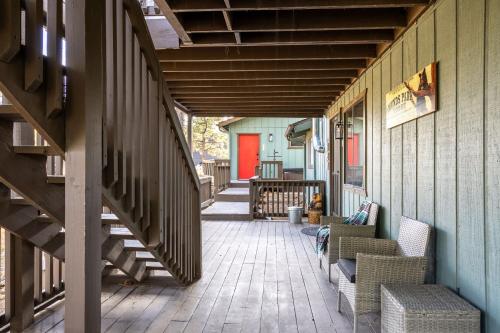 a porch with chairs and stairs on a house at The Pine Perch in Munds Park