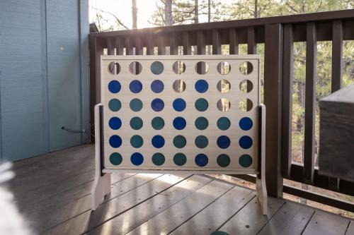 a large blue and white checker board on a deck at The Pine Perch in Munds Park