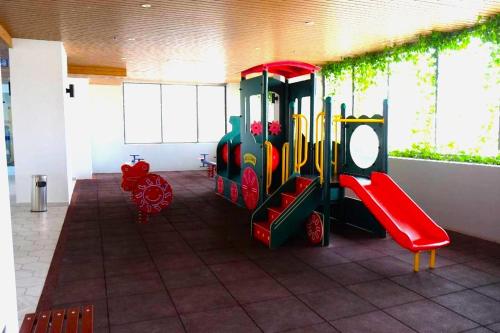 a childrens play area with a train on a playground at Atlantis Residences Melaka in Melaka