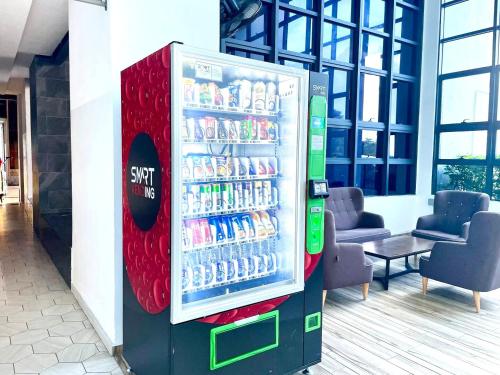 a soda vending machine in a building at Atlantis Residences Melaka in Melaka