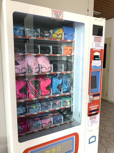 a vending machine filled with lots of shoes at Atlantis Residences Melaka in Melaka