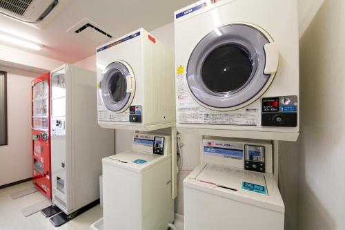 a washing machine and a dryer in a room at Urban Hotel Minami Kusatsu in Kusatsu