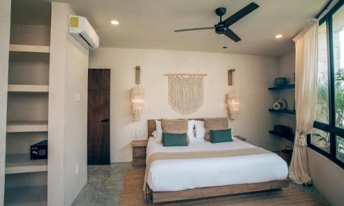 a bedroom with a bed and a ceiling fan at Tulum Jungle Luxury Villa -Pvt Pool - Concierge 6A in Tulum