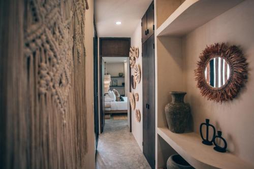 a hallway with a mirror on the wall at Tulum Jungle Luxury Villa -Pvt Pool - Concierge 6A in Tulum