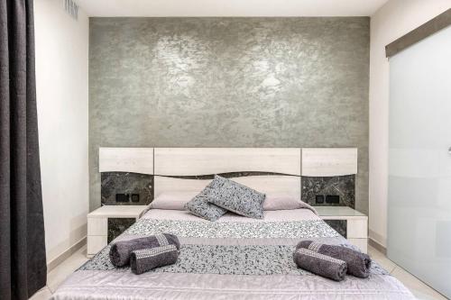 a bedroom with a bed with two pillows on it at Luxury Cosy 3 Bedroom Apt in Gzira, close to Sliema StJulians by walk in Il-Gżira