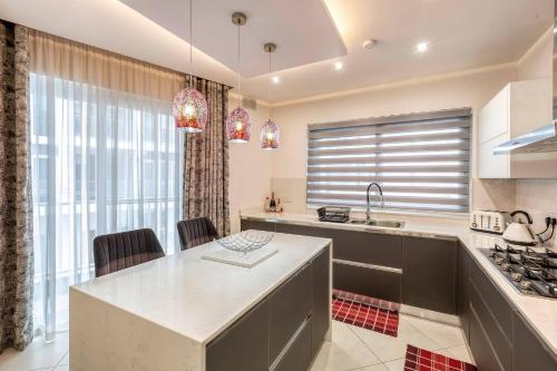a kitchen with a sink and a counter top at Luxury Cosy 3 Bedroom Apt in Gzira, close to Sliema StJulians by walk in Il-Gżira