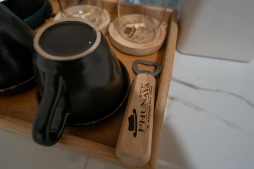a pair of shoes on a wooden shelf with glasses at Phunaya Phuket Oldtown Hotel in Phuket Town