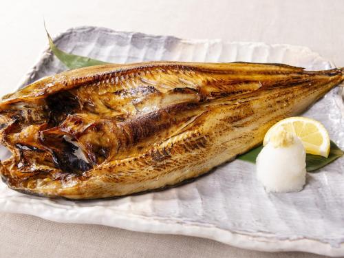 two fish on a plate with a lemon slice at Hotel Wing International Chitose in Chitose
