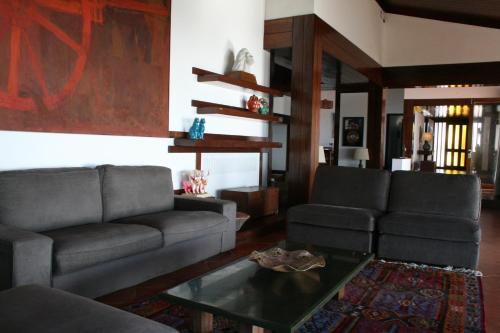 a living room with two couches and a coffee table at Herdade AMÁLIA RODRIGUES in Zambujeira do Mar