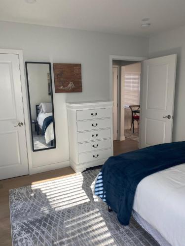 a bedroom with a bed and a dresser and a mirror at 2 Palo Alto - Fully Furnished with Parking, Laundry, AC, Private in East Palo Alto
