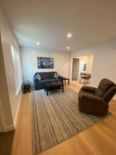 a living room with a couch and a chair at 2 Palo Alto - Fully Furnished with Parking, Laundry, AC, Private in East Palo Alto