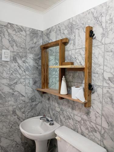 a bathroom with a sink and a mirror at Flor de Espinillo Estancia Grande in Estancia Grande