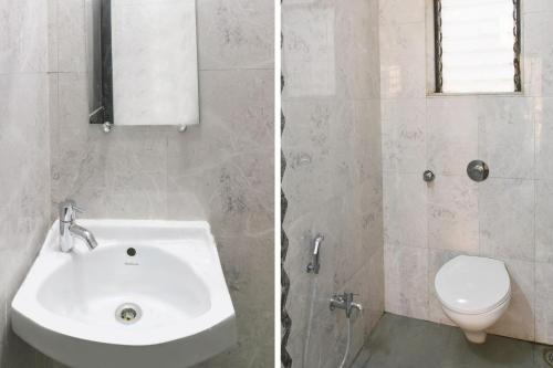 a white bathroom with a sink and a toilet at Hotel O GEMS STAR RESIDENCY BNB Bamandongri Railway Station in Belapurpāda