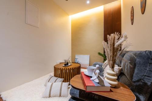 a living room with a couch and a table at La Ferringhi Villa - Balinese Collection, by ALV in Batu Ferringhi