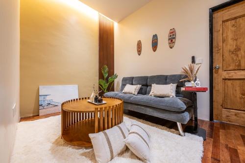 a living room with a couch and a table at La Ferringhi Villa - Balinese Collection, by ALV in Batu Ferringhi