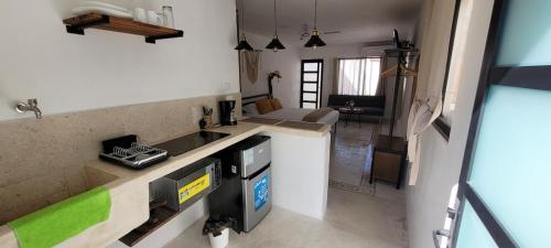 a kitchen with a sink and a counter top at Pakáal Muliix - Limóm in Mérida