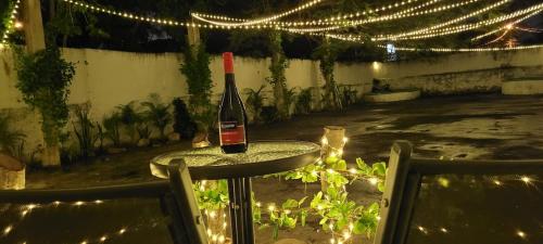 a bottle of wine sitting on a table with lights at Pakáal Muliix - Limóm in Mérida