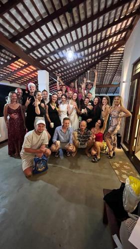 a group of people posing for a picture in a room at The Green Lagoon Villa in Hikkaduwa