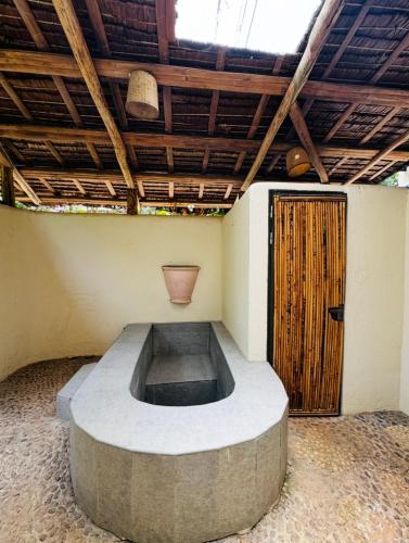 a circular room with a wooden door in a building at Tahanan Resort in San Juan