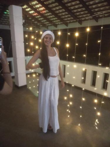 a woman in a white dress standing on a dance floor at The Green Lagoon Villa in Hikkaduwa