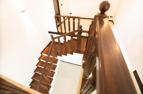 a wooden spiral staircase in a house at The Green Lagoon Villa in Hikkaduwa