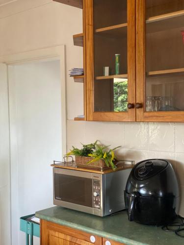 a microwave sitting on a counter in a kitchen at Campbeltown Private Room in Campbelltown South