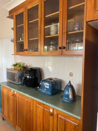 a kitchen counter top with a toaster and a tea kettle at Campbeltown Private Room in Campbelltown South
