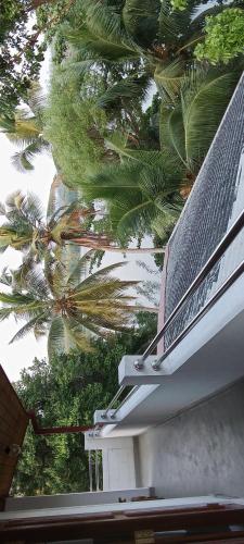 a view of the top of a house with palm trees at The Green Lagoon Villa in Hikkaduwa