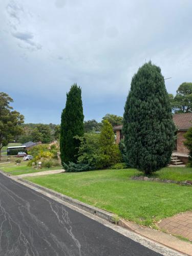 a house with two trees on the side of a street at Campbeltown Private Room in Campbelltown South
