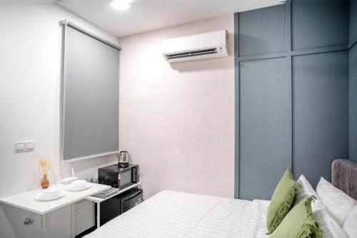 Postel nebo postele na pokoji v ubytování Neu Suites by COBNB