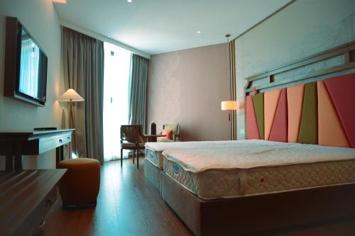 Postel nebo postele na pokoji v ubytování APEC MŨI NÉ MANDALA