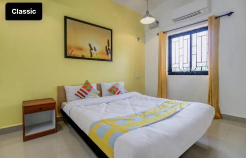 a bedroom with a large bed and a window at Exotic stay in Nerul