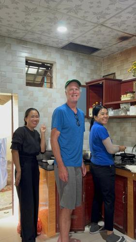 a group of three people standing in a kitchen at Seagull Nest Hoi An Beach Village in Tân Thành (1)
