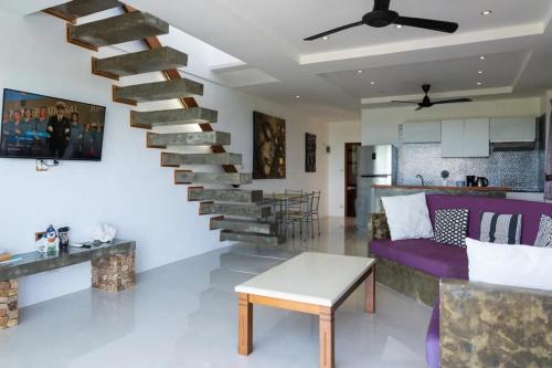 a living room with a spiral staircase in a house at Duplex 2br Pool & Seaview - Chaweng in Chaweng