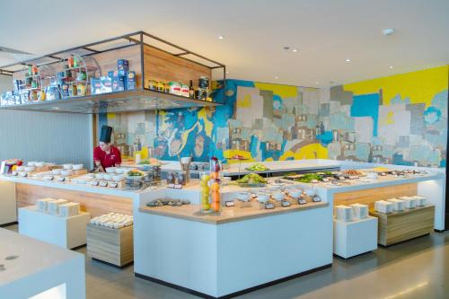 a restaurant with a buffet of food on display at CENTRAL PLAZA HOTEL - Mỹ Tho in My Tho