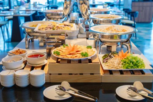 a buffet with several plates of food on a table at CENTRAL PLAZA HOTEL - Mỹ Tho in My Tho