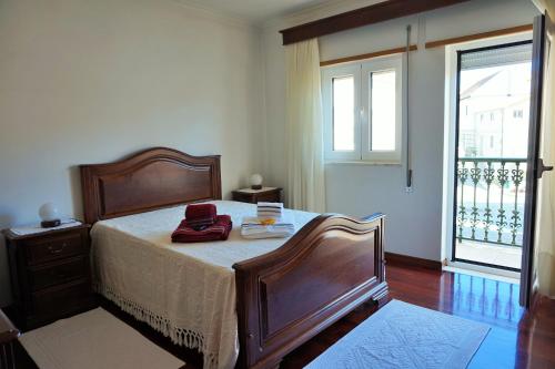 a bedroom with a bed with a dresser and a window at Casa de Campo Neves in Montalegre
